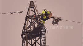 Ingenious high-wire cable winding machine used to run cable between pylons in Kent, UK
