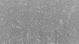 Massive sized snowflakes fall in Waterloo Ontario Canada in what might be one of the last snow events as winter gives way to spring.