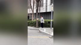 Bark missing from tree where elderly man pats it as part of his workout