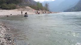 swimming on the koshi river. Out standing game by a boy.  High risk swimming.