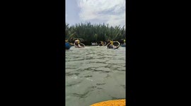 Tourists watch boatmen skilfully spinning around on water's surface in Vietnam