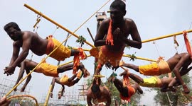 Tamil men show extreme devotion by piercing bodies and swinging from cranes at Panguni Uthiram Festival