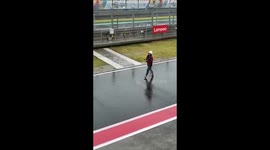 Female 'rain handler' tries to stop a downpour at the Mandalika Indonesia Moto GP