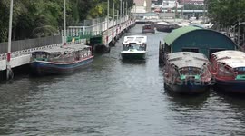 Solar-powered electric boats ferry commuters along canals in Bangkok, Thailand