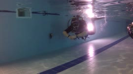 Divers training in a pool doing their `Ocean Diver ` course, having a swim around after