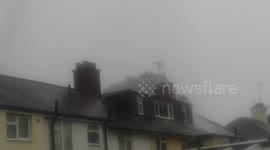 Rear view of Water main pipe burst sending 40-50ft of water in the air