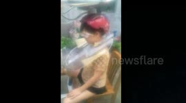 Woman tests automatic hair washer