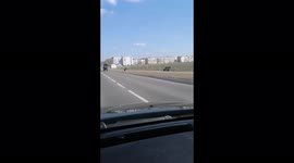 Strange transport on the road from a horse, cart and car