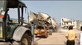 JCB shattered to pieces after being struck by collapsing building