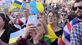Woman standing in a crowd at the London Stands with Ukraine: March and Vigil, chanting