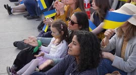 Woman with child sitting at the London Stands with Ukraine: March and Vigil