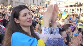 Side view of a woman clapping at London Stands with Ukraine: March and Vigil