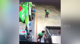 Bored pump attendant plays 'football' in petrol station using plastic bottle and rubbish bin