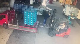 Forklift truck driver accidentally knocks over dozens of bottles