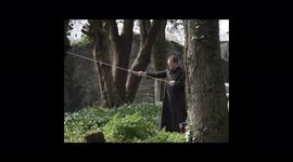 A frocked Priest volunteers to assist a dangerous tree felling operation in a Convent garden in Cornwall UK