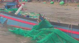 Dozens of boats broken by waves washed up on the coast of Vietnam after the tropical depression passed