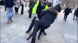 Protester held back by police as anti-vaccine protesters mob Cressida Dick