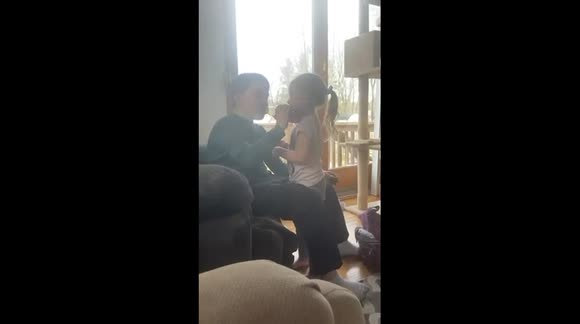 Little sister trying to hug brother;headbutts and hugs