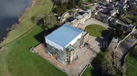 Drone footage of Ripley Castle with scaffolding and the roof covered during restoration