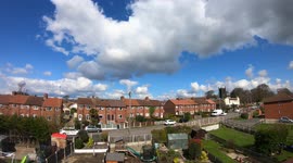 Time lapse of Cumulus clouds speeding over a suburban village of Leeds