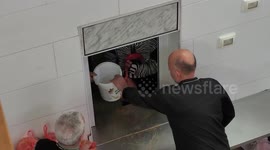 Palestinians prepare a dish for free fast-breaking Iftar rations to families in need, at the Ibrahimi Takiya in the West Bank city of Hebron.