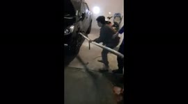 Multiple firefighters pull huge python from car's engine in Indonesia