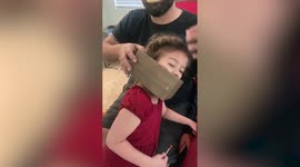 Funny moment 5-year-old gets box shelf stuck on her head after using it as crown