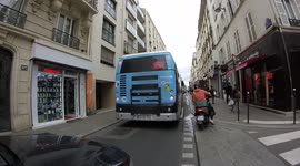 Food delivery (Deliveroo,Ubereats) drivers riding on the sidewalk full of people. Paris, France, rue Raymond Losserand. 6april2022.
