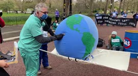 Activists dressed as doctors attempt to 'revive' Earth in climate protest in London