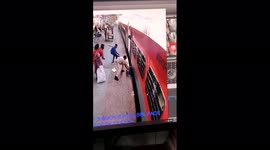 Watch - Man slips while trying to board running train , rescued by police personnel