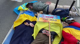 Protesters stage a die-in outside the Russian Embassy in London