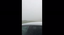 Watch as Tennessee storm chaser gets caught in a barrage of hail, driving rain and storm force winds