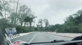 SUV spins out of control on wet road in Thailand