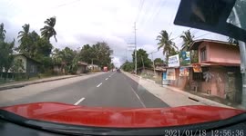 Car narrowly misses motorcycle rider and pillion passenger who suddenly cross road