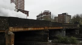 Beautiful steam train leaves London's Victoria under a billow of smoke