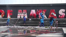 Officers clean the tourist location of Losari Beach Pavilion, Makassar