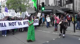 women in green with green flag extinction rebellion oxford street