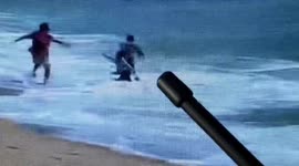 Lifeguards rescue kids being swept into sea by waves on beach in China