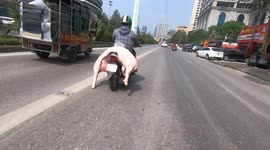 Close up of man transporting pig carcasses on a motor-scooter