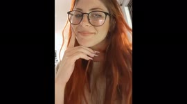 Girl petting her hand Red devil cichlid fish in the aquarium