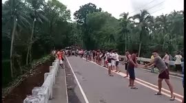 Long row of people unload relief goods after Storm Megi hit Philippines