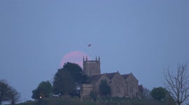Spectacular full moon rises above St Arilda's Church in Gloucestershire