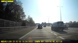 Dashcam near miss where car swerves into hard shoulder to avoid rear end collision with car in front and rejoins queue further on