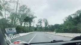 SUV spins out of control on wet road in Thailand