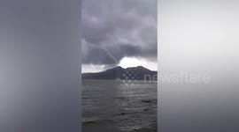 Massive waterspout forms next to passing pump boat in the Philippines