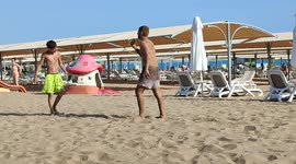 German youths on holiday in Turkey throwing sand at each other and acting irresponsible