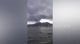 Massive waterspout forms next to passing boat in the Philippines