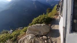 Hair-raising highway: Bus driver calmly navigates rugged road with lethal drop just inches away