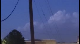 MYSTERIOUS FLYING OBJECT FLIES THROUGH SKY  IN BROAD DAYLIGHT