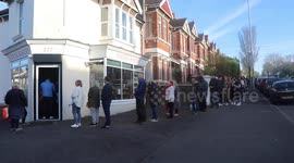 Dozens of people queue for hot cross buns at Brighton Ravens bakery this Good Friday